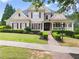 Charming two-story home with manicured lawn, brick walkway, and inviting front porch at 4526 Meadow Club Dr, Suwanee, GA 30024