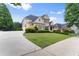 Spacious two-story home with a long driveway, lush lawn, and well-maintained landscaping at 4526 Meadow Club Dr, Suwanee, GA 30024