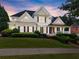 Beautiful two-story home with manicured lawn, shrubbery, and classic architectural details at 4526 Meadow Club Dr, Suwanee, GA 30024