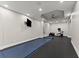 A home gym with rubber flooring, wall-mounted TV, weights, and an octagon ceiling design at 4526 Meadow Club Dr, Suwanee, GA 30024