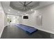 This home gym shows an open floor plan, mirrored wall, and glass doors to the exterior at 4526 Meadow Club Dr, Suwanee, GA 30024