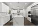 Bright kitchen with stainless steel appliances, modern cabinetry, and a large waterfall island at 4526 Meadow Club Dr, Suwanee, GA 30024