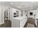 Spacious kitchen with a central island, stainless steel appliances, and a seamless connection to the living area at 4526 Meadow Club Dr, Suwanee, GA 30024