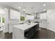 Bright kitchen with stainless steel appliances, white cabinets, and a large central island at 4526 Meadow Club Dr, Suwanee, GA 30024