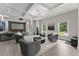 Relax in this living room featuring tray ceilings, recessed lighting, and a modern fireplace at 4526 Meadow Club Dr, Suwanee, GA 30024