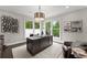 Home office features a large desk, ample natural light, and views of the lush surroundings at 4526 Meadow Club Dr, Suwanee, GA 30024