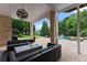 Inviting covered patio with a fire pit, outdoor seating, and views of the pool and backyard at 4526 Meadow Club Dr, Suwanee, GA 30024
