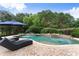 Luxurious pool with lounge seating and umbrella, perfect for enjoying sunny days in a private setting at 4526 Meadow Club Dr, Suwanee, GA 30024