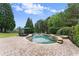 Beautiful pool area with a spa, lounge chairs, and lush landscaping for a relaxing outdoor experience at 4526 Meadow Club Dr, Suwanee, GA 30024