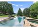 Refreshing swimming pool and spa with a stone surround, inviting relaxation and outdoor enjoyment at 4526 Meadow Club Dr, Suwanee, GA 30024