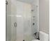 Modern bathroom with a glass shower enclosure and tiled walls and floors at 4526 Meadow Club Dr, Suwanee, GA 30024