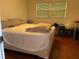 Bedroom with a large bed, bedside table, and a window for natural light at 4701 Cleveland Rd, Lithonia, GA 30038