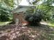 Two-story brick home on a wooded lot with mature trees and natural landscaping, a secluded retreat at 4701 Cleveland Rd, Lithonia, GA 30038