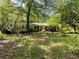 Charming single-story home with brick facade and a lush, treed front yard at 4701 Cleveland Rd, Lithonia, GA 30038