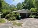 Attached garage and side view of the house surrounded by abundant vegetation at 4701 Cleveland Rd, Lithonia, GA 30038