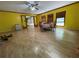 Spacious living room with light colored wood floors, a ceiling fan, and large window at 4701 Cleveland Rd, Lithonia, GA 30038