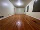 View of the very large living room with wood flooring and great light at 4701 Cleveland Rd, Lithonia, GA 30038