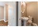 Powder room featuring a pedestal sink and a decorative mirror at 620 Waynes Se Ct, Atlanta, GA 30354
