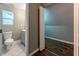 Powder room featuring a door into an unfinished basement and a tile floor at 620 Waynes Se Ct, Atlanta, GA 30354
