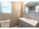 Bathroom with gray vanity, solid-surface top, single sink, and a large mirror at 620 Waynes Se Ct, Atlanta, GA 30354