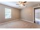 Neutral bedroom featuring plush carpeting, a ceiling fan, and natural light at 620 Waynes Se Ct, Atlanta, GA 30354
