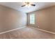 Neutral bedroom with plush carpeting, ceiling fan, and bright window at 620 Waynes Se Ct, Atlanta, GA 30354