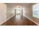 Open-concept living room with recessed lighting, wood-look floors, a ceiling fan, and natural light from large windows at 620 Waynes Se Ct, Atlanta, GA 30354