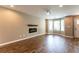 Living room featuring hardwood floors, a fireplace, and bay windows at 620 Waynes Se Ct, Atlanta, GA 30354