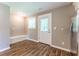 Bright mud room featuring wood-look floors, a window, a door to the backyard, and a stainless steel refrigerator at 620 Waynes Se Ct, Atlanta, GA 30354