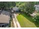 Aerial view of home with long driveway, carport, fenced yard, and mature trees at 730 Brownwood Se Ave, Atlanta, GA 30316