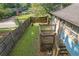 View of the cozy backyard with privacy fence, a small wooden deck, and grassy area at 730 Brownwood Se Ave, Atlanta, GA 30316