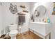 Bathroom featuring modern sink vanity, mounted decor and wood-look floors at 730 Brownwood Se Ave, Atlanta, GA 30316