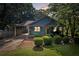 Charming house featuring a carport, front porch, nicely manicured bushes, and a grassy front yard at 730 Brownwood Se Ave, Atlanta, GA 30316