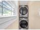 Laundry area with stackable washer and dryer and a bright window view at 730 Brownwood Se Ave, Atlanta, GA 30316