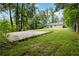Spacious backyard featuring a large concrete slab and lush greenery, perfect for outdoor activities at 924 Sweetwater Cir, Lawrenceville, GA 30044