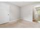 The bedroom features neutral paint, carpet flooring, a closet, and a window at 924 Sweetwater Cir, Lawrenceville, GA 30044