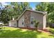 View of this house with stone details, a chimney, and a well-kept lawn at 924 Sweetwater Cir, Lawrenceville, GA 30044