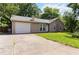 Well-maintained house with a garage, stone accents, and a long driveway leading to the entrance at 924 Sweetwater Cir, Lawrenceville, GA 30044