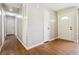 Hallway showing a wooden door with a window pane and wood-look floors at 924 Sweetwater Cir, Lawrenceville, GA 30044