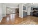 Spacious living room featuring wood flooring, fireplace, and an open layout with a view into the kitchen at 924 Sweetwater Cir, Lawrenceville, GA 30044