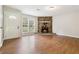 Cozy living room featuring hardwood floors, a stone fireplace, and an entrance door at 924 Sweetwater Cir, Lawrenceville, GA 30044