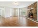 Bright living room with wood floors, stone fireplace, and natural light from large windows at 924 Sweetwater Cir, Lawrenceville, GA 30044