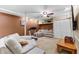 Finished basement featuring carpet, a treadmill, seating area, and a television at 119 Castlewood Rd, Tyrone, GA 30290