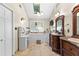 Bright bathroom featuring double sinks, vanity, skylight and tile floors at 119 Castlewood Rd, Tyrone, GA 30290
