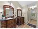 Bathroom featuring double sinks with dark cabinets and a shower at 119 Castlewood Rd, Tyrone, GA 30290