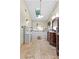 Bright bathroom featuring double sinks, vanity, skylight and tile floors at 119 Castlewood Rd, Tyrone, GA 30290
