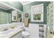 Stylish bathroom with decorative walls, framed mirror, patterned shower curtain and window at 119 Castlewood Rd, Tyrone, GA 30290