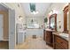Bright bathroom featuring double sinks, vanity, skylight and tile floors at 119 Castlewood Rd, Tyrone, GA 30290