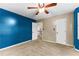 Well-lit bedroom featuring blue walls, built-in shelves, and large windows at 119 Castlewood Rd, Tyrone, GA 30290