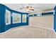 Well-lit bedroom featuring blue walls, built-in shelves, and large windows at 119 Castlewood Rd, Tyrone, GA 30290